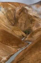 Steaming stream between colourful rhyolite mountains, Hveradalir geothermal area, Kerlingarfjöll,