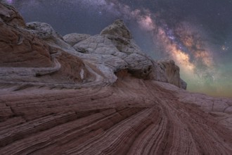 Stunning nightscape of White Pocket in Arizona showcases the Milky Way galaxy arching over unique