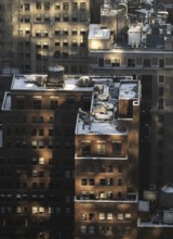Top view of a New York City block capturing buildings bathed in the golden light of sunset,