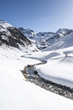 Funtauna Valley with mountain stream and snow in winter, Graubünden Haute Route, Albula Alps,