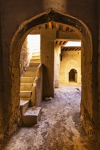 View into an arched vault with staircase, in the largest preserved mud town in Oman, Al Bilaad, Al
