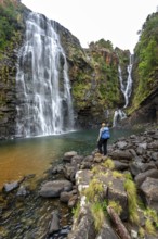 Young woman standing in front of a waterfall, Lisbon Falls, long exposure, near Graskop,