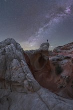 A stunning nightscape of the Milky Way galaxy arching over the unique rock formations at White