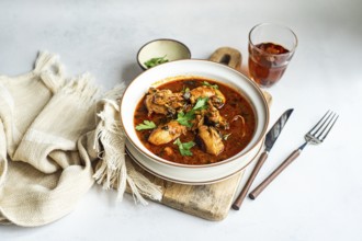 Savor this authentic Georgian chakhokhbili, a hearty chicken stew cooked in rich tomato sauce,