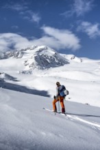 Ski tourers, behind the summit of Monte Cevedale, snow-covered mountain landscape, Ortler Alps,