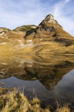 Lake Augstsee and the Atterkogel mountain on the Loser. Autumn, good weather, blue sky. Reflection.