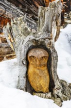 Owl carved from a tree stump, surrounded by snow, Chandolin, Val d'Anniviers, Valais Alps, Canton