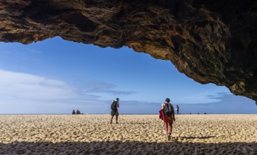 Tourists watch the waves of the Atlantic on the rocky plateau of Sito, also known as Forte São