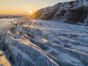 Breathtaking beauty of Glacier in Skaftafell under a golden winter sunrise. The scene captures the