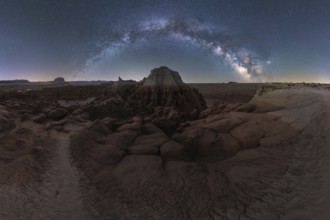 A breathtaking panorama of the Milky Way arcing over the uniquely eroded rock formations of Goblin