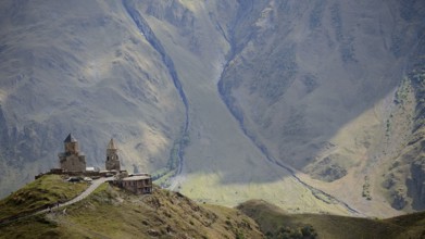 Gergeti church on a mountain with breathtaking mountain scenery, Stepantsminda, Caucasus, Georgia