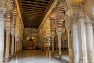 Elongated hall with columns and Moorish arches inside the Cathedral Mosque of Córdoba