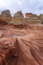 Striking view of the swirling red and beige rock formations of White Pocket, located in Arizona's