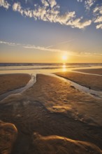 Atlantic ocean sunset with surging waves at Fonte da Telha beach, Costa da Caparica, Portugal