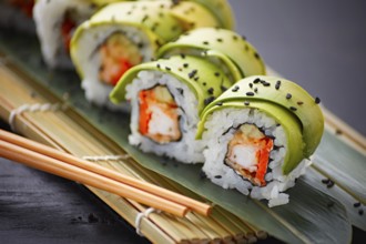 Delectable sushi rolls, elegantly wrapped in slices of avocado, served on a traditional bamboo mat.