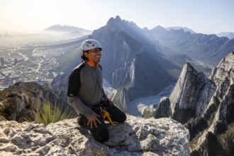 A man takes a break after practicing mountaineering and rappelling at Eagle's Nest in Monterrey,