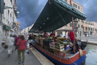 Selling fruit and vegetables from a boat, Venice, Veneto, Italy