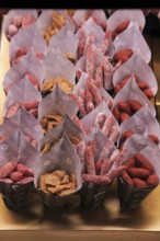 Small sausages packed for sale, Mercado San Miguel market, Madrid city centre, Spain