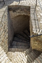 Descending stone staircase made of bricks with rustic charm, Jerez