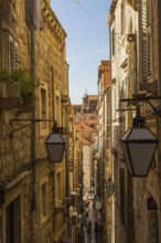 High angle view of narrow street with tourists and visitors in old walled city of Dubrovnik,