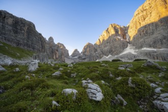 Picturesque mountain landscape in Val Brenta Alta at sunrise, rocky peaks of Cima Tosa,