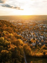 Autumnal cityscape in the evening light, wide view of houses and forests, Herrenberg, Germany