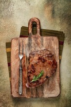 Grilled steak, beef steak, rib eye steak, on a chopping board, top view, no people