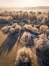 Village with trees and tepee, frozen landscape in warm morning light, day care centre, Gechingen,