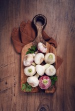 Fresh young garlic, white and purple color, on a wooden table, no people