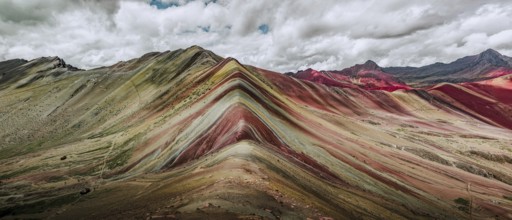A stunning panoramic capture of Vinicunca, or Rainbow Mountain, famous in Peru for its colorful,