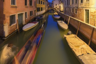 Evening gondola ride on a side canal in the Dorsoduro district, Venice, Veneto, Italy