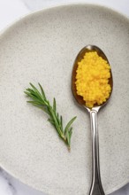 Yuzu caviar is pearly, on a spoon, top view, light background, no people