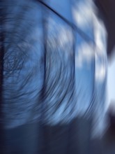 A captivating abstract photograph featuring a swirling motion blur against a blue background. The