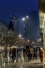 Rainy weather, freezing rain, pedestrian zone Zeil, shopping street, high-rise skyline in clouds,