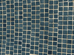 A close-up of a surface adorned with small, blue square tiles arranged in a geometric pattern. The