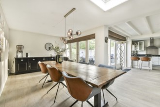 A bright and spacious modern dining room featuring a stylish table, elegant chairs, and large