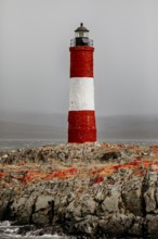 Lighthouse on a rocky island in the sea under a stormy sky, The lighthouse in the Beagle Channel