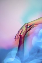 A close-up image of two multiethnic hands reaching towards each other in a gesture of unity and