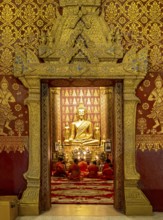 Monks praying at Wat Sensoukharam, Luang Prabang, Laos