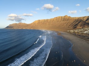 Risco de Famara cliffs and sea with Famara beach, in the evening light, Playa de Famara, aerial