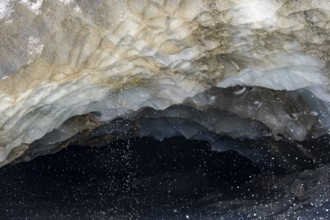 Meltwater at a glacier cave, underground glacier stream, Castner Glacier, Delta Range, Alaska