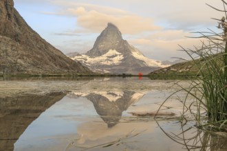 Stunning landscape of the Matterhorn reflected in a serene alpine lake, surrounded by the majestic