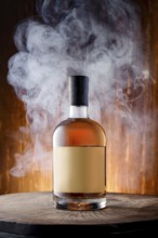 Bottle of blended malt smoked scotch whisky surrounded with smoke on wooden background