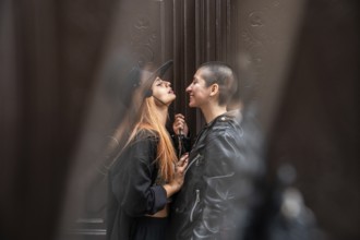 A lesbian couple sharing an intimate moment, surrounded by soft, muted surroundings. One partner in