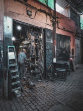 Small, dark workshop full of cables and metal in the Medina with craftsmen at work, atmospheric