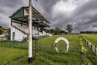 Sports ground with stand and green area under a dramatically cloudy sky, The Nuwara Eliya Sri Lanka