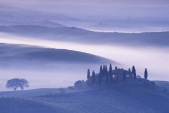Landscape in Tuscany in the morning mist, Podere Belvedere winery in Val d'Orcia
