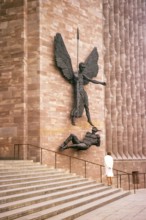 Standing woman with view of the sculpture Coventry Cathedral Church, West Midlands, England, United
