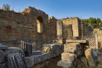 Phidias' workshop, ancient ruins with decorative columns against the blue sky, archaeological site,