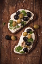 Breakfast, sandwiches, with cream cheese, olives, top view
